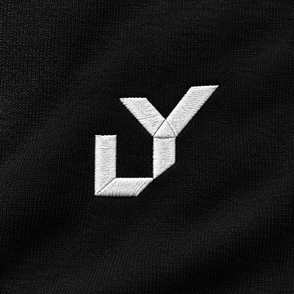 White LY embroidery on a black UNRULY hoodie